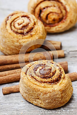 Cinnamon rolls on rustic rough wooden table