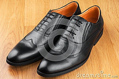 Classic men s shoes stand on the wooden floor