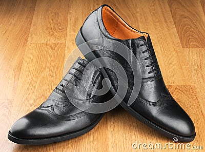 Classic men s shoes stand on the wooden floor