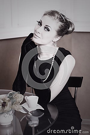 Retro styling woman in black dress and gloves