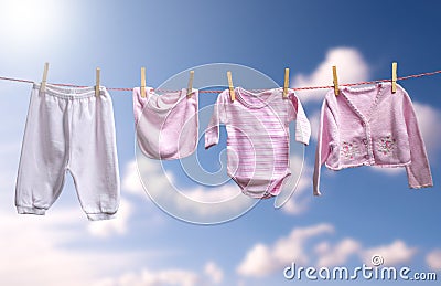 Clean baby girl clothes on the outdoor clothesline