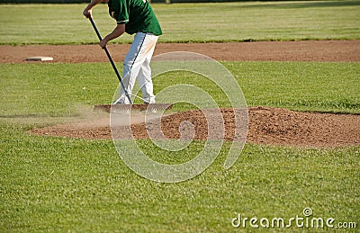 Cleaning the pitcher s mound after a game