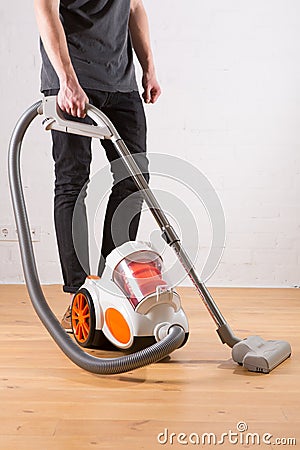 Cleaning with vacuum cleaner in living room