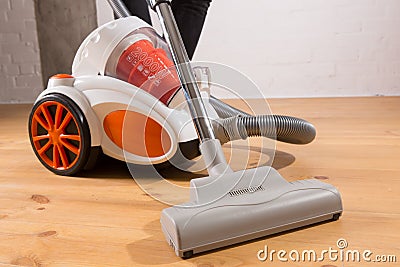 Cleaning with vacuum cleaner in living room