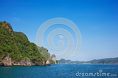 Cliff and the clear sea with long-tail near Phi Phi island in south of Thailand