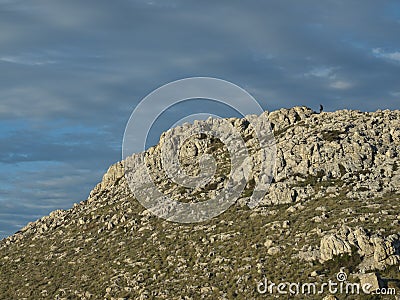 Climber in the distance, climbing the hill