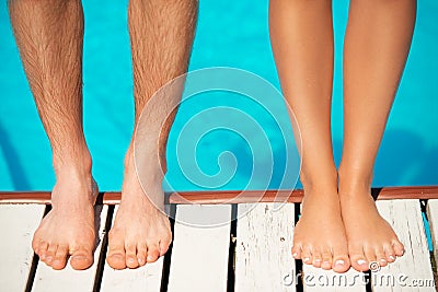 Close-up of beautiful woman and man legs near by