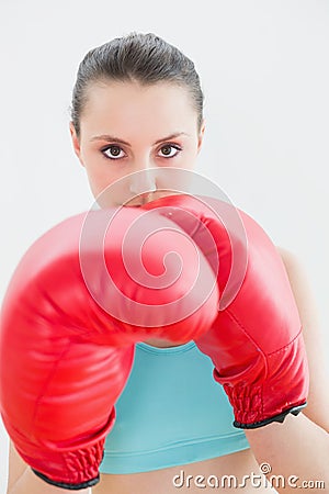 Close up of beautiful woman in red boxing gloves