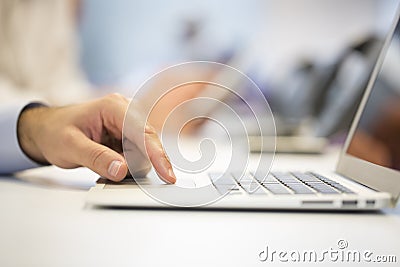 Close-up of businessman hands typing on laptop, Office Backgrou