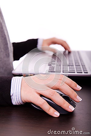 Female hand on mouse while working on laptop