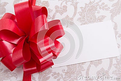 Close up of gift box with big bow and empty greeting card