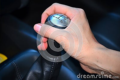 Close up of hand on manual gear shift knob