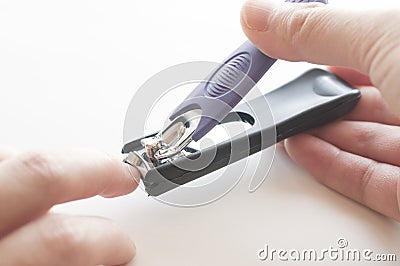 Close up of hand with nail clipper