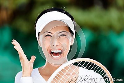 Close up of happy woman with tennis racquet