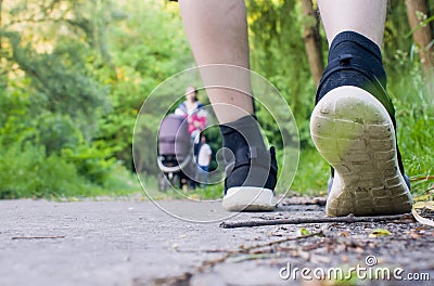 Close-up of male feet in sneakers running outdoors