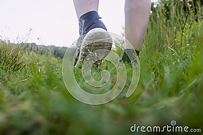 Close-up of male feet in sneakers running outdoors