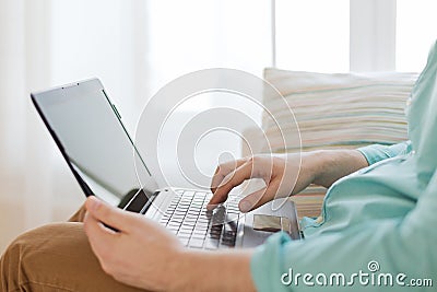 Close up of man working with laptop at home