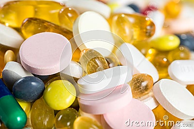 Close-up medicinal drugs, pills and capsules in capsules and tablets on white background.