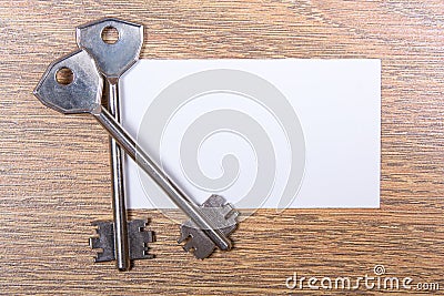 Close up of metal keys and visiting card on the table