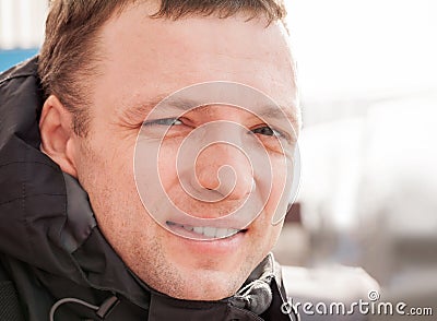 Close up outdoor portrait of young smiling man