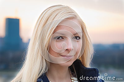 Close up portrait of a beautiful blonde girl over sunset
