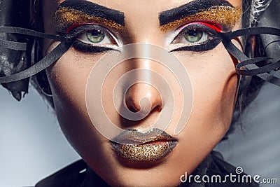 Close up portrait of charming adult woman with gold lips