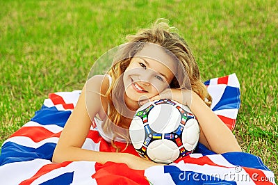 Close up portrait of cute little football fan girl.