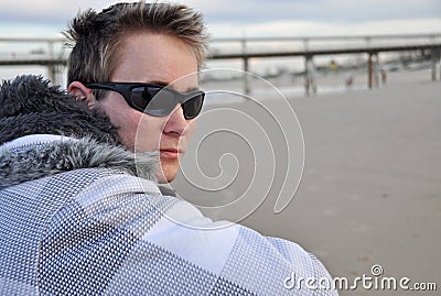 Time out - Young man alone on white sandy beach