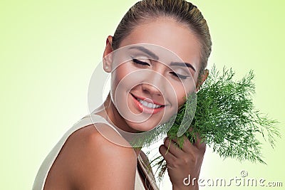 Close-up portrait of happy young woman with bundle herbs (dill)