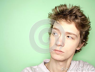 Close up portrait of young man thinking and looking away left.