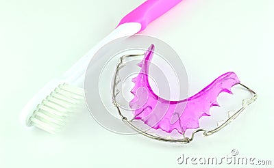 Close up of purple dental braces and toothbrush