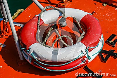 Close-up of a red and white weatherd life-belt (buoyancy aid) on