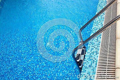 Close-up shot of swimming pool with ladder