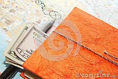 Close-up Travel Arrangement of Dollars , Map and notepad diary