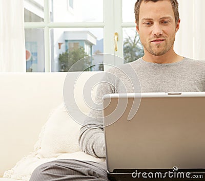 Close up view of professional man with laptop and smart phone at home.