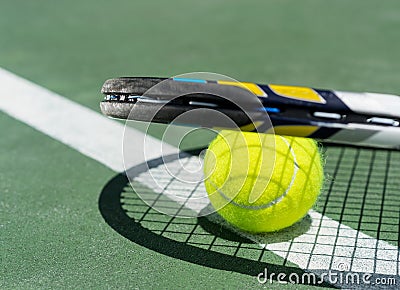 Close up view of tennis racket and balls