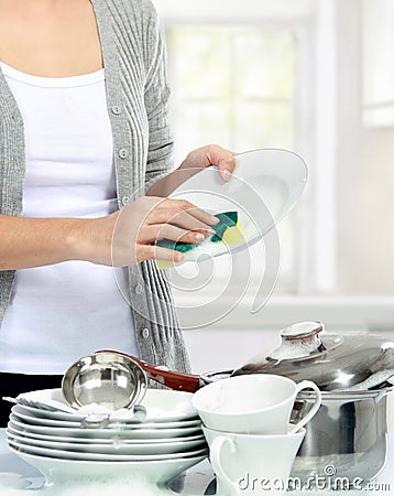 Woman washing dishes in the kitchen