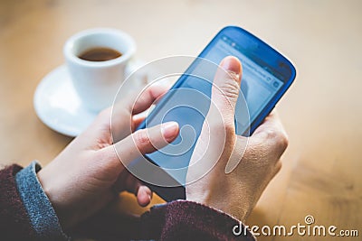 Close up of woman hands with smartphone coffee