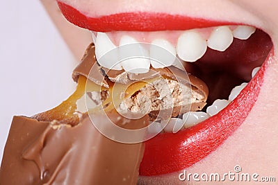 Close-up woman with white teeth and chocolate