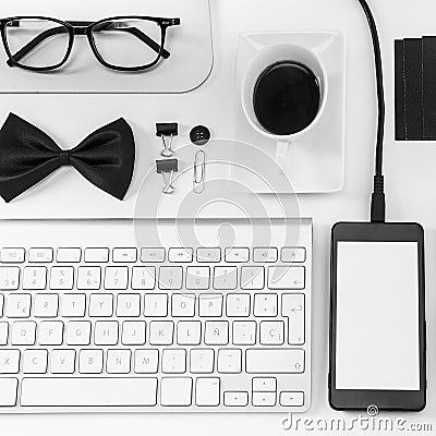 Closeup of business objects in order on white desk.