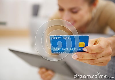 Closeup on credit card in hand of young woman