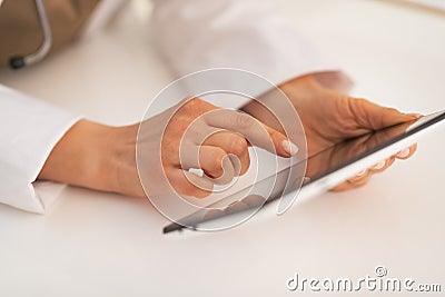 Closeup on doctor woman using tablet pc