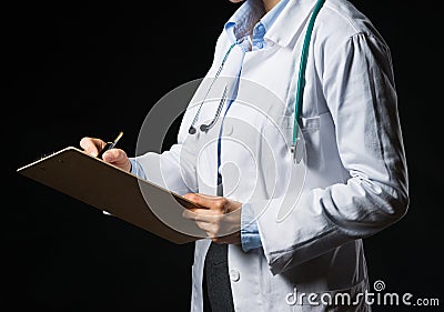 Closeup on doctor woman writing in clipboard