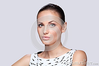 Closeup on elegant woman in fashionable stylish white dress posing in studio.