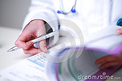 Closeup of a female doctor looking a medical file