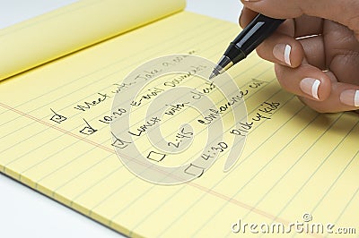Closeup Of Female s Hand Writing List Of Tasks To Do