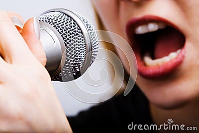 Closeup on female singer mouth and microphone