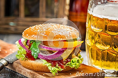 Closeup of fresh burger and a cold beer