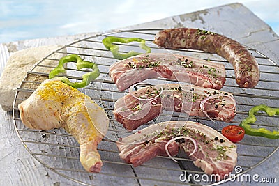 Closeup of fresh meat and sausages on barbecue grid