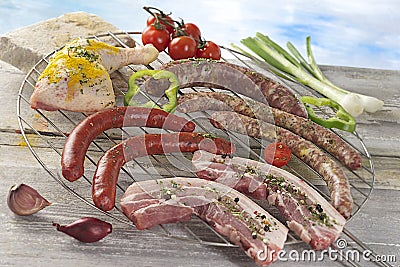 Closeup of fresh meat and sausages on barbecue grid